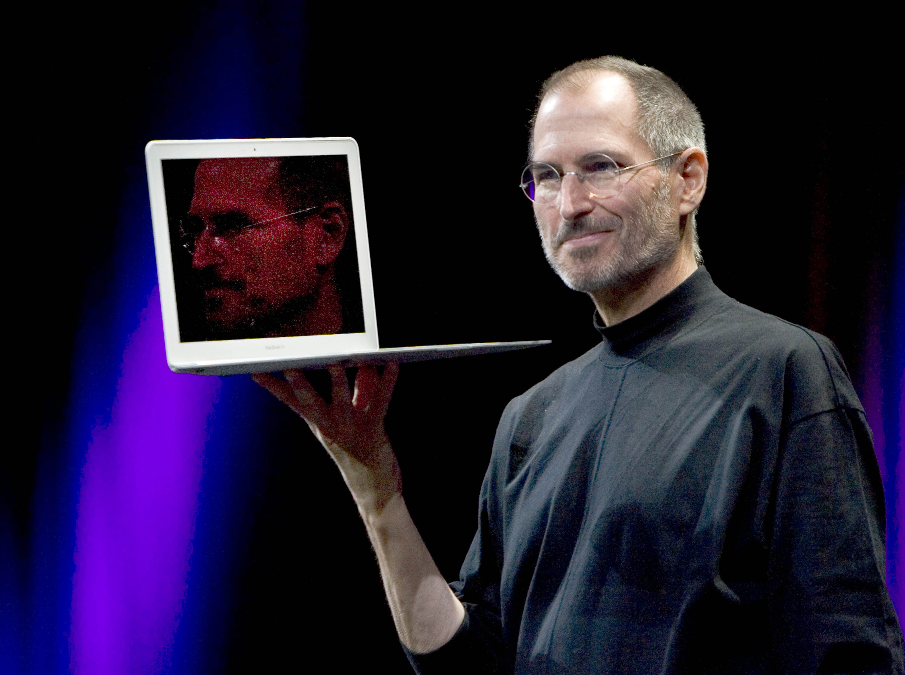 Apple co-founder Steve Jobs, seen in this file photo from January 15, 2008 while holding up the MacBook Air, right, has died. Jobs was 56. (Robert Durell/Los Angeles Times/MCT)