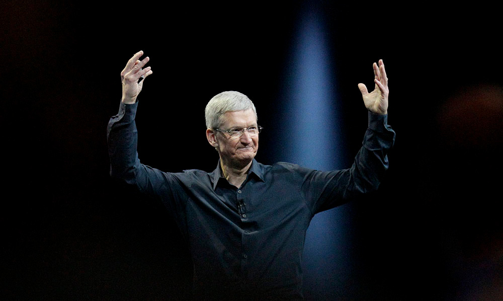 Apple CEO Tim Cook gestures while speaking at the Apple Worldwide Developers Conference in San Francisco, Monday, June 2, 2014. Apple's Mac operating system is getting a new design and better ways to exchange files, while new features in the software for iPhones and iPads include one for keeping tabs on your health. (AP Photo/Jeff Chiu)